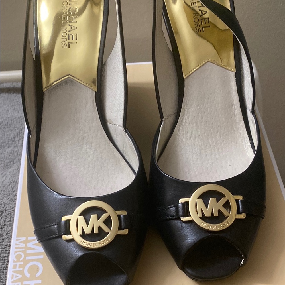 Michael Kors Black and Gold Heels with MK Logo in wore them one time.